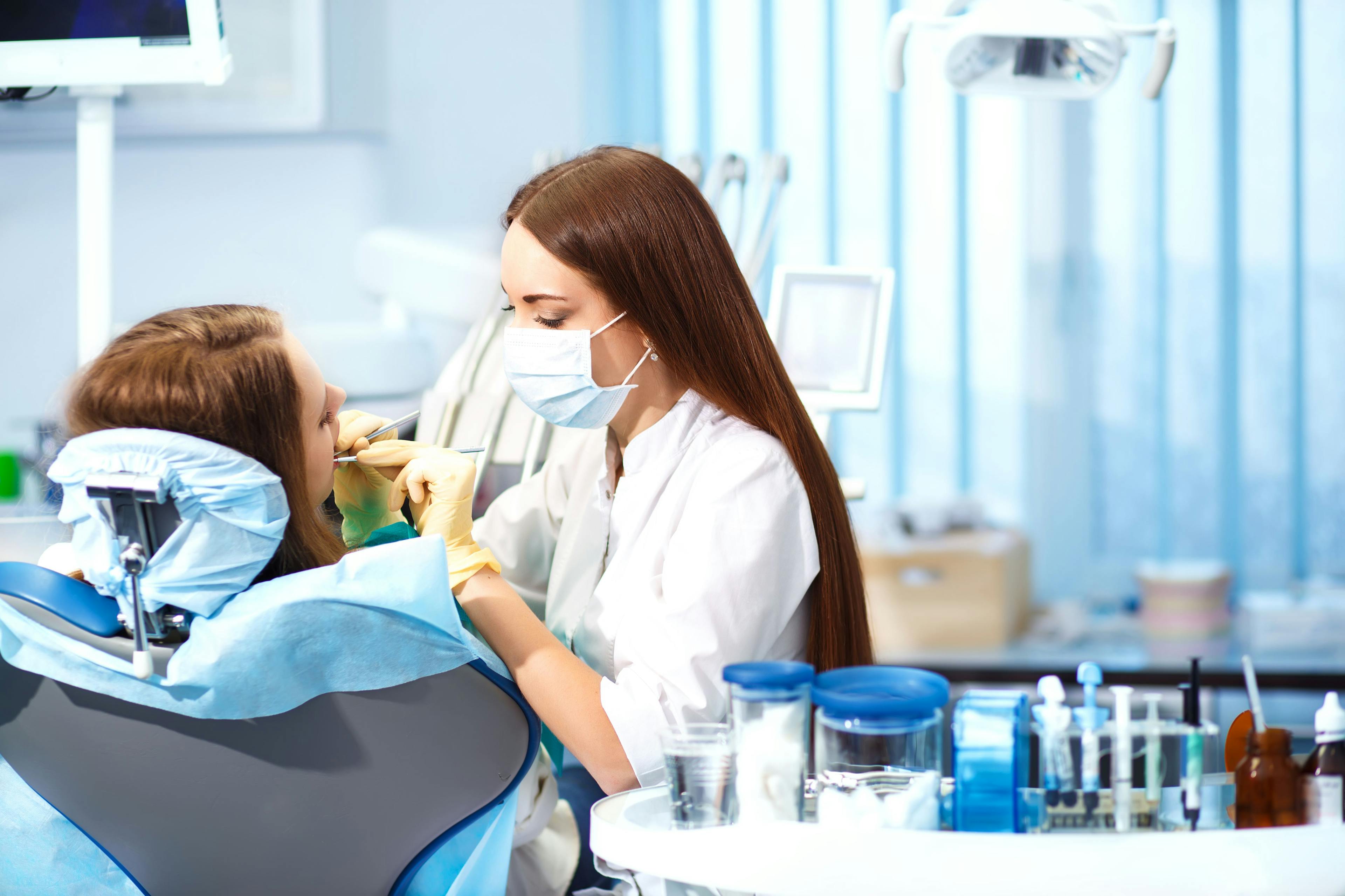 Professional woman dentist doctor working. woman at dental clinic. lady woman at dentist taking care of teeth. Dental care for people. Dentist holding dental device for fixing teeth. | ©maxbelchenko - stock.adobe.com